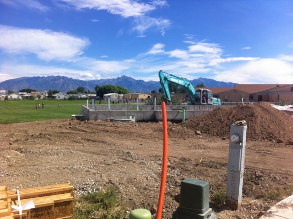 Week 4--Basement floor poured, window wells in, plumbing started