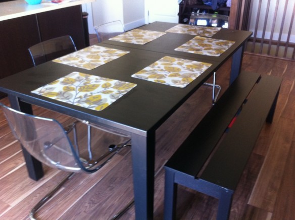 Our table with a bench and four funky chairs that we love. The kids love how rainbows sprout up on the floor when the light hits the chairs just right.